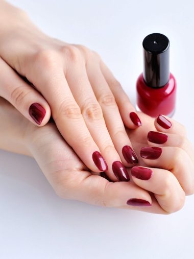 hands-of-a-woman-with-dark-red-manicure-and-nail-P5VNS4S.jpg